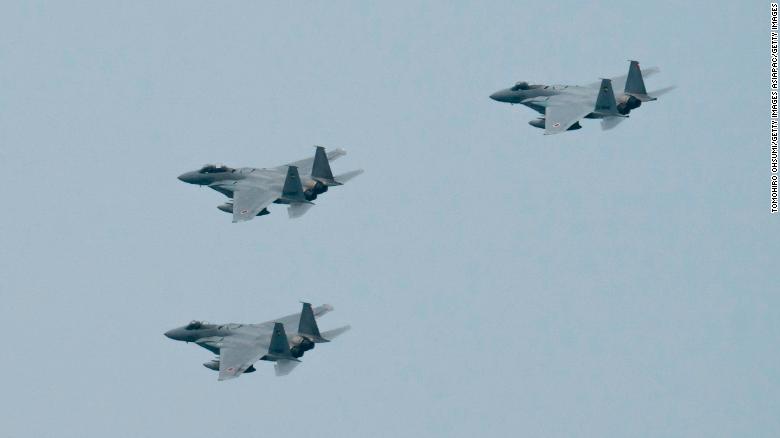 Japan&#39;s Air Self-Defense Force&#39;s F-15 fighter jets, one of the country&#39;s key defenses, fly during a review after the graduation ceremony of the National Defense Academy on March 22, 2020.