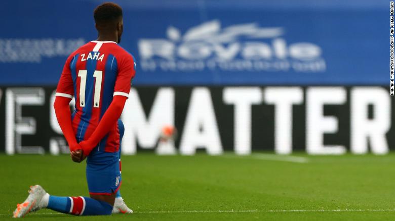 Wilfried Zaha takes a knee in support of the Black Lives Matter movement before the matcha against Burnley.