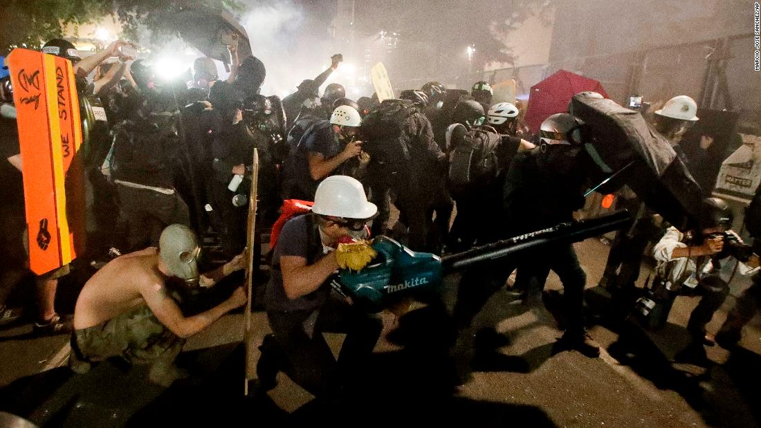 Protesters blow back tear gas with leaf blowers on July 29.