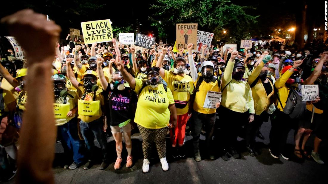 The &quot;Wall of Moms&quot; protest group marches with other demonstrators on July 28.