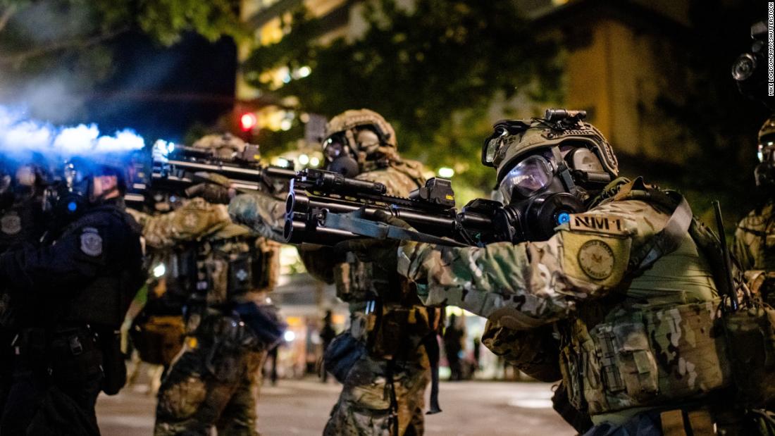 Federal officers attempt to clear the crowd on July 27.