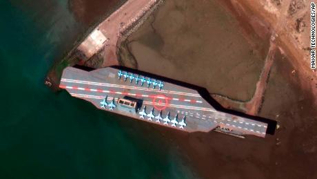 In a February 15 satellite photo provided on July 27 by Maxar Technologies, a mockup aircraft carrier built by Iran is seen at Bandar Abbas before being put to sea. 