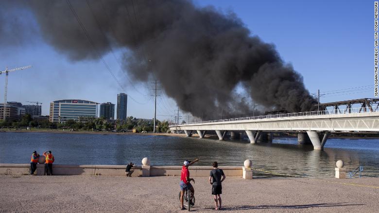 Bystanders watch scene of derailment Wednesday in Arizona.