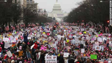 Protesters walk during the Women&#39;s March on Washington, with the US Capitol in the background, on January 21, 2017 in Washington, DC. 