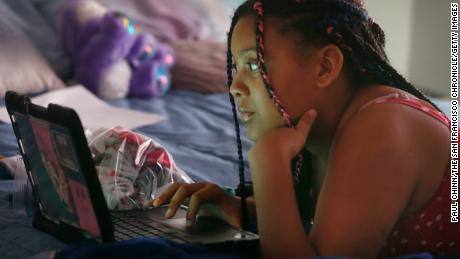 Alayjah Burnett, 13, attends an online class at her home in Vallejo, California on Thursday, April 23, 2020. Alayjah&#39;s mom, Michelle Burnett, says she&#39;s worried about the shift toward distance learning. &quot;I just feel like she&#39;s going to get left in the dust,&quot; she says.