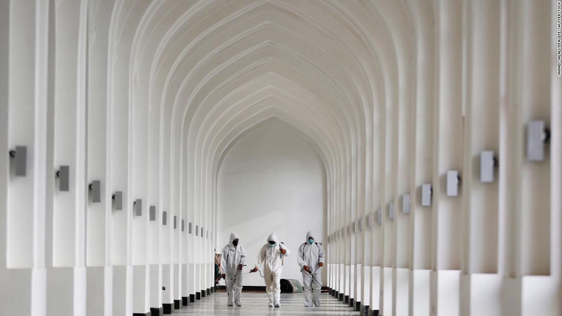 Volunteer health workers disinfect a mosque prior to Eid al-Adha prayers in Kabul, Afghanistan, on July 31.