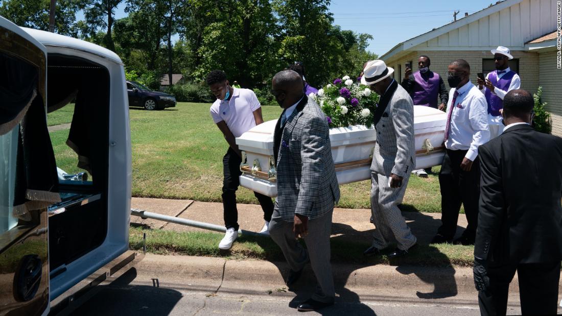 A casket carrying the body of coronavirus victim Lola M. Simmons is placed into a hearse following her funeral service in Dallas on July 30.