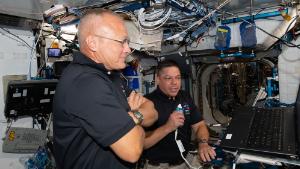 NASA astronauts Doug Hurley (foreground) and Bob Behnken, who flew the Crew Dragon spacecraft to the International Space Station during SpaceX Demonstration Mission-2, are pictured briefing mission controllers about their experience in the new vehicle on June 1, 2020.