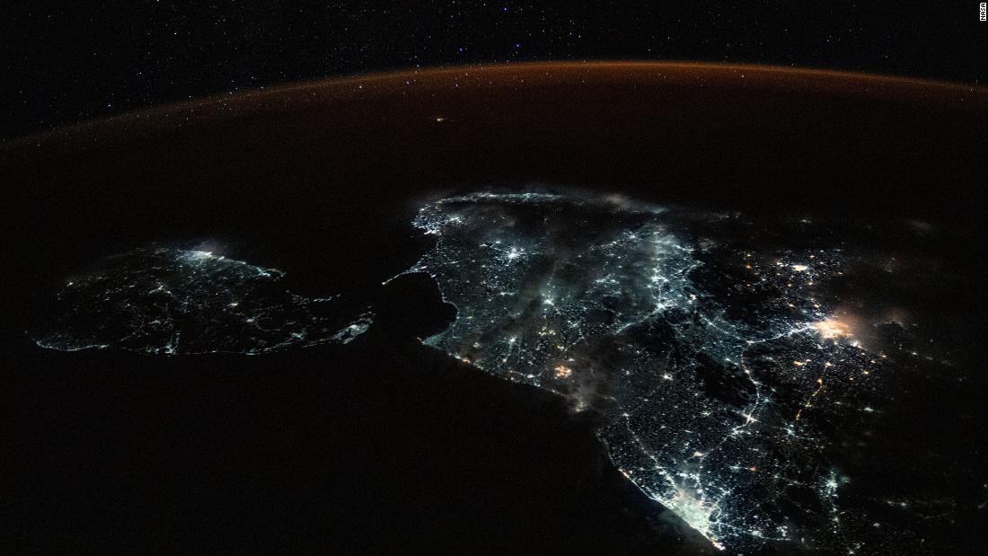 Sri Lanka and the brightly lit southern tip of India are shown in this photograph from the International Space Station on July 24. A starry sky and an atmospheric glow frame the Earth&#39;s horizon.
