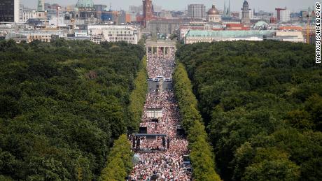 Thousands attend a protest against coronavirus restrictions at the Brandenburg Gate in Berlin on Saturday, August 1.