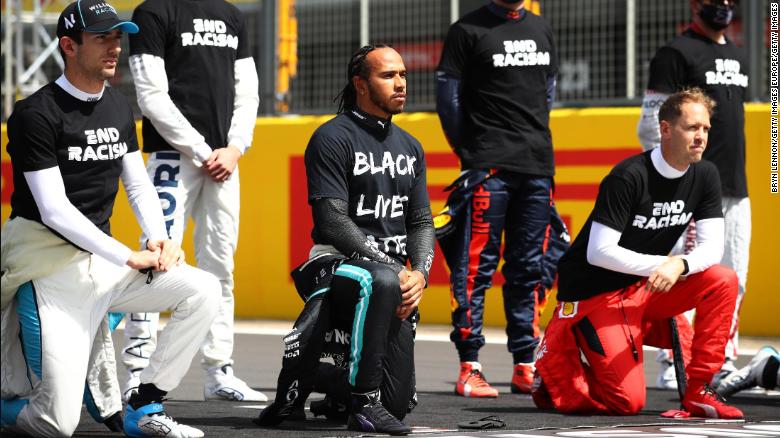 Lewis Hamilton takes a knee on the grid in support of the Black Lives Matter movement.