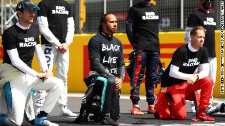 Lewis Hamilton takes a knee on the grid in support of the Black Lives Matter movement.