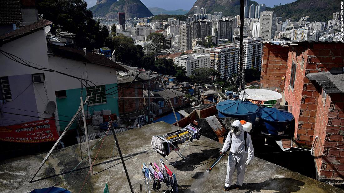 A volunteer disinfects a rooftop area in Rio de Janeiro on August 1.