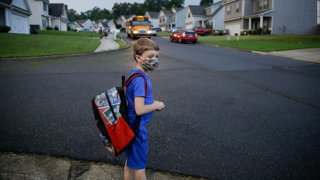 Paul Adamus, 7, waits at the bus stop for his first day of school in Dallas, Georgia, on August 3.