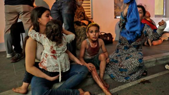 Wounded people wait to receive help outside a hospital. Emergency wards were inundated.