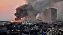 A helicopter fights a fire at the scene of an explosion in Beirut, Lebanon, on Tuesday, August 4.