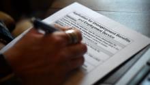 In this photo illustration, a person files an application for unemployment benefits in April 2020 in Arlington, Virginia. 