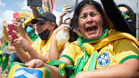 A supporter of Brazilian President Jair Bolsonaro cries during a demonstration in support of his government amid the coronavirus pandemic in front of the Planalto Palace on May 24, 2020 in Brasilia, Brazil. 