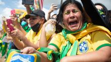 A supporter of Brazilian President Jair Bolsonaro cries during a demonstration in favor of his government amidst the coronavirus pandemic in front of Planalto Palace on May 24, 2020 in Brasilia, Brazil. 