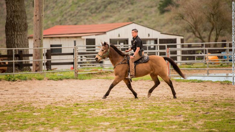 Senior Airman Michael Terrazas, 30th Security Forces Squadron conservation patrolman, does arena work in 2019 with military working horse Buck at Vandenberg Air Force Base in California. 