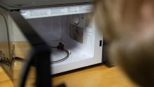 Dr. Michael Pecht of the University of Maryland&#39;s Center for Advanced Life Cycle Engineering looks at an AmazonBasics microwave from a customer who said it caught on fire. 