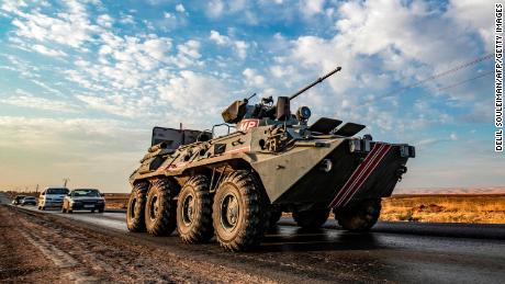 A Russian military police armored personnel carrier (APC) drives along a road in the countryside near the northeastern Syrian town of Amuda in Hasakeh province on October 24, 2019, as part of a joint patrol between Russian forces and Syrian Kurdish Asayish internal security forces near the border with Turkey. 