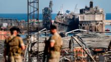 Lebanese soldiers stand guard in front of destroyed ships Thursday, August 6, at the scene of Tuesday's explosion in Beirut, Lebanon.