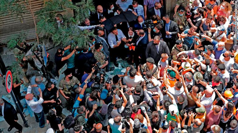 French President Emmanuel Macron speaks to the crowd in Beirut's Gemmayzeh neighborhood, which suffered extensive damage in Tuesday's massive explosion.