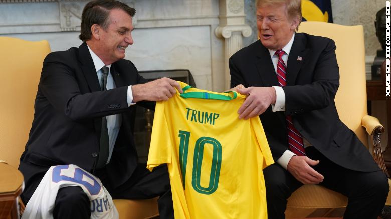 Brazilian President Jair Bolsonaro, left, presents US President Donald Trump with a Brazil national soccer team jersey at the White House on March 19, 2019 in Washington, DC.