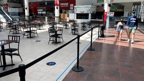 People walk past the nearly empty food court at Providence Place shopping mall, on June 1, 2020, in Providence, R.I. 