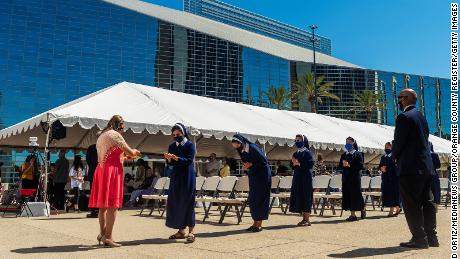 Sisters line up for communion during outdoor mass at Christ Cathedral in Garden Grove, California, on Sunday, July 19, 2020. 