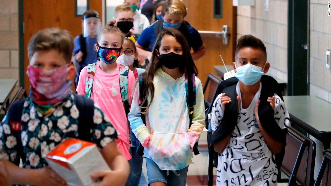 Elementary school students walk to class in Godley, Texas, on August 5. Three rural school districts in Johnson County were among the first in the state to head back to school for in-person classes.