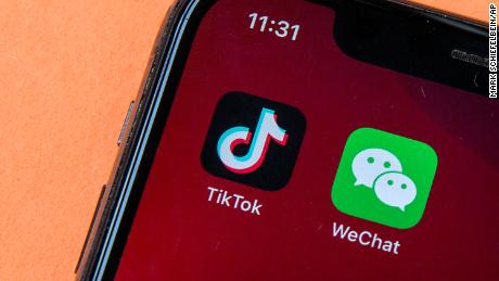 Icons for the smartphone apps TikTok and WeChat are seen on a smartphone screen in Beijing, Friday, Aug. 7, 2020. President Donald Trump has ordered a sweeping but unspecified ban on dealings with the Chinese owners of the consumer apps TikTok and WeChat, although it remains unclear if he has the legal authority to actually ban the apps from the U.S. (AP Photo/Mark Schiefelbein)