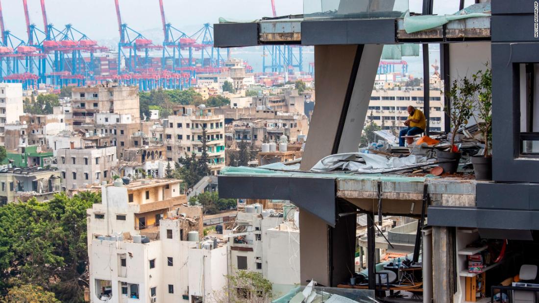 A man sits inside a damaged home in Beirut on August 7, 2020.