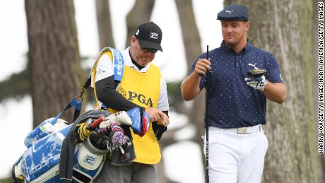 DeChambeau fixes his new shaft to his driver.