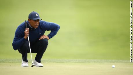 Woods lines up a putt on the 13th green.