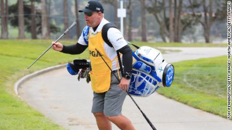 DeChambeau&#39;s caddie Tim Tucker carries the US golfer&#39;s new driver shaft.