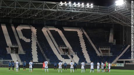 Players from Atalanta and Brescia -- another team based in Lombardy -- pay their respects in memory of Covid-19 victims prior to the Serie A match between the two teams in July.