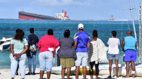 Bystanders look on near Blue Bay Marine Park on August 6.