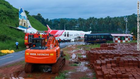 A man walks near the wreckage of the Air India Express plane on Saturday.