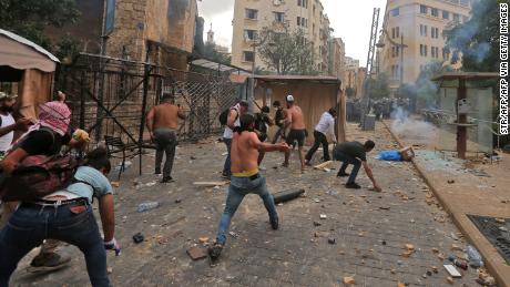 Protesters hurl rocks towards security forces during clashes in downtown Beirut, Lebanon, on Saturday.