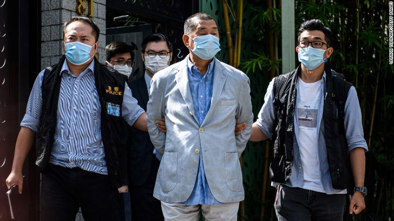 Police lead Hong kong pro-democracy media mogul Jimmy Lai (C), 72, away from his home after he was arrested under the new national security law in Hong kong on August 10, 2020.