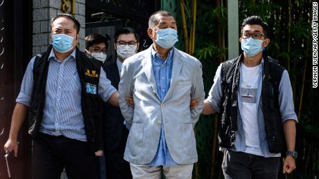 Police lead Hong kong pro-democracy media mogul Jimmy Lai (C), 72, away from his home after he was arrested under the new national security law in Hong kong on August 10, 2020.