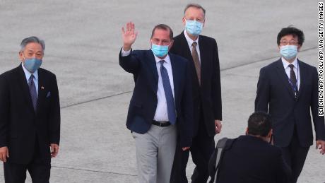 US Health Secretary Alex Azar waves to  journalists as he arrives at Songshan Airport in Taipei on August 9, 2020.