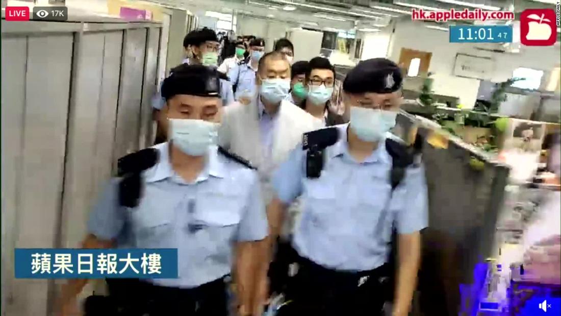 Jimmy Lai is escorted through the Apple Daily newsroom after being arrested under Hong Kong&#39;s national security law in August 2020.