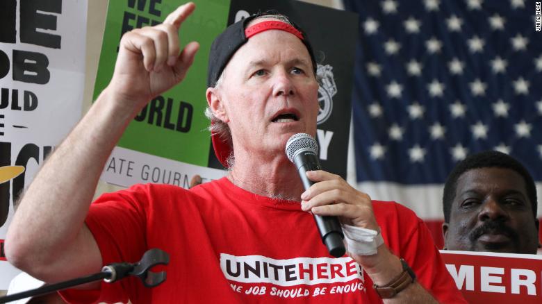 UNITE HERE International President D. Taylor (center) speaks during a June 2019 protest in support of airport workers at Ronald  Reagan International Airport in Washington D.C.