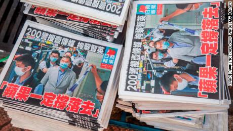 Copies of the Apple Daily newspaper -- paid for by a collection of pro-democracy district councillors -- sit on a cart before being handed out in Hong Kong on August 11, 2020, a day after authorities conducted a search of the newspaper&#39;s headquarters after the companys founder Jimmy Lai was arrested under the new National Security Law.  