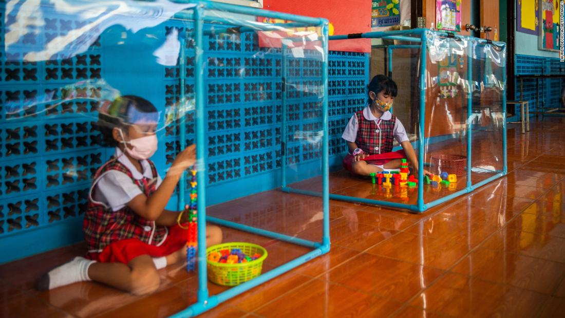 Kindergarten students wear face masks and play in screened-in areas at the Wat Khlong Toey School in Bangkok, Thailand, on August 10.