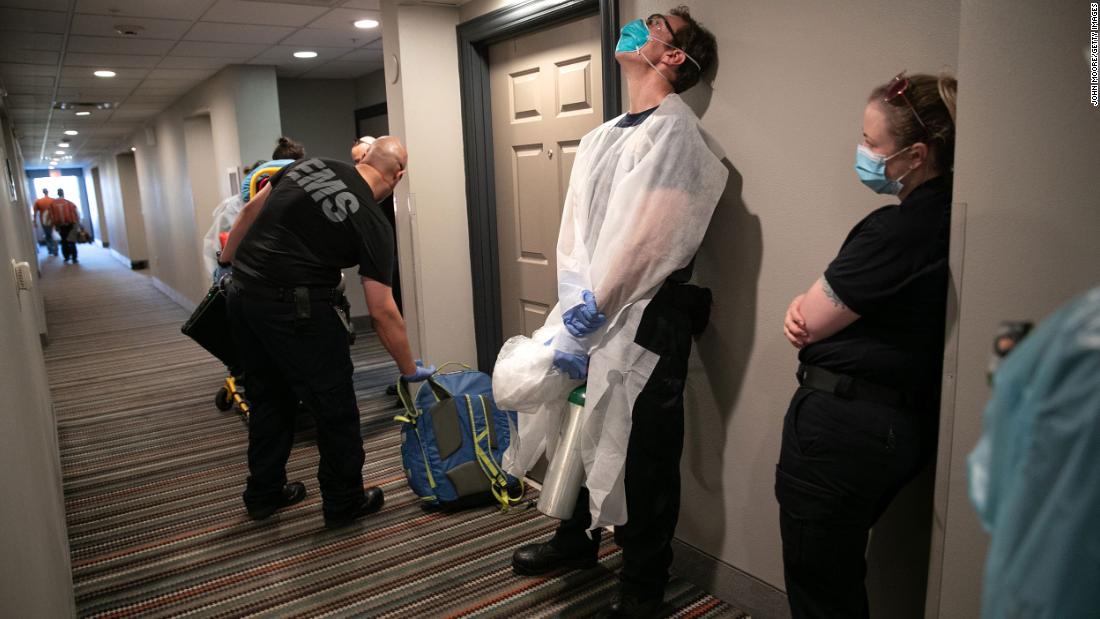 Medics wait to transport a woman with possible Covid-19 symptoms to a hospital in Austin, Texas, on August 7.