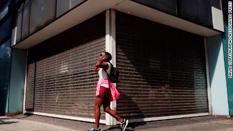 A woman walks past a vacant retail unit on Oxford Street in London, England, on July 22, 2020. UK retail sales data for June, during which non-essential shops were allowed to reopen, is set to be released by the Office for National Statistics (ONS) this Friday, July 24.  (Photo by David Cliff/NurPhoto via AP)